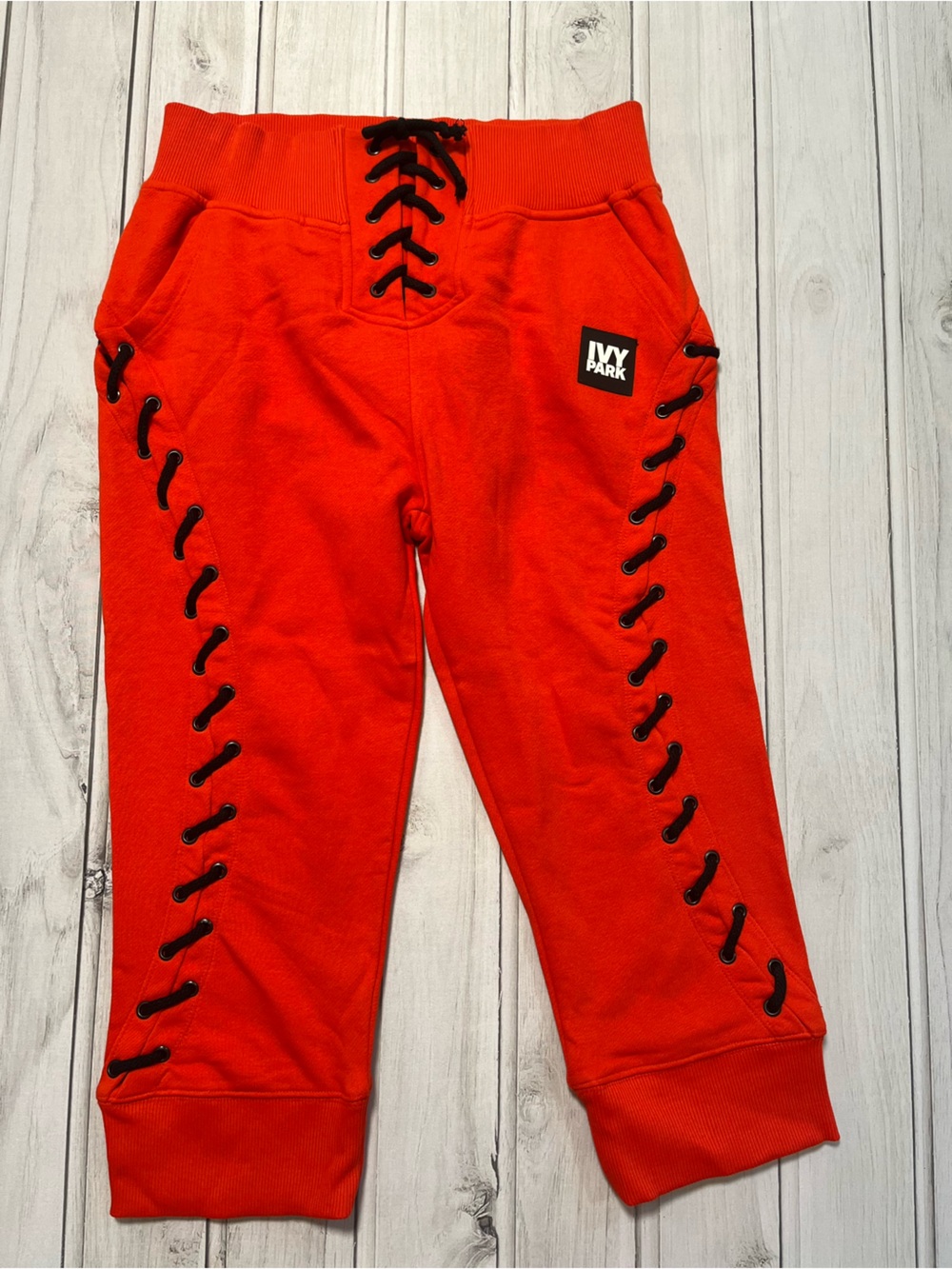 Women’s Ivy Park red with black lace up detail sweatpants joggers. Size small.